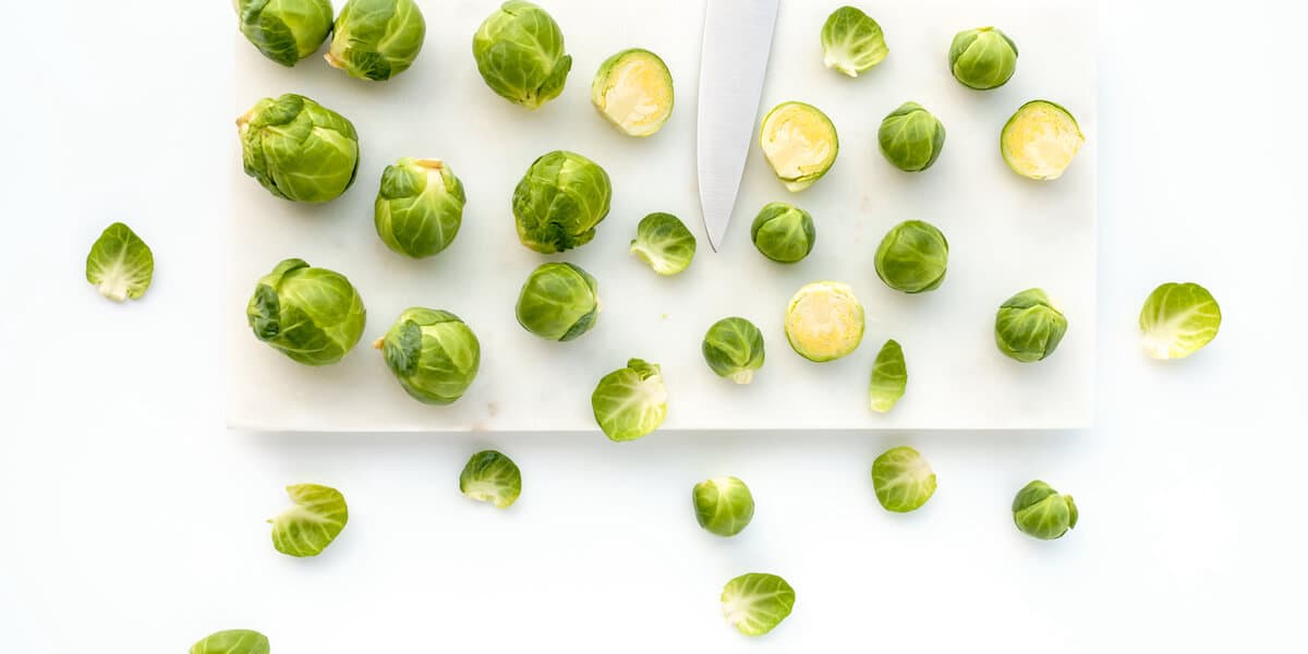 Brussels Sprouts and Knife on White Marble